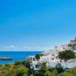 View of the bay and snow-white houses of the ancient city of Lindos on the Greek island of Rhodes, view of the Aegean Sea, the islands of the Dodecanese archipelago, Europe