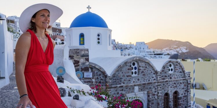 Beautiful womanwith hat in Oia