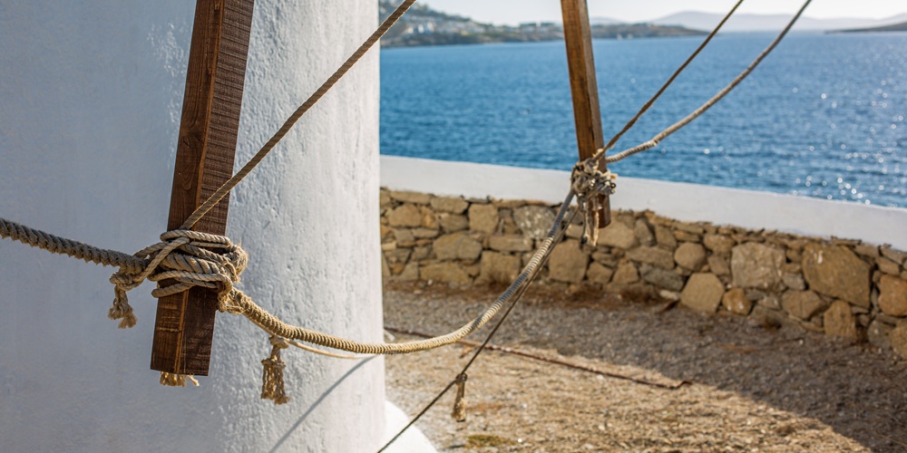 Selective focus shot of a lower part of a tower at the ocean in Mykonos, Greece